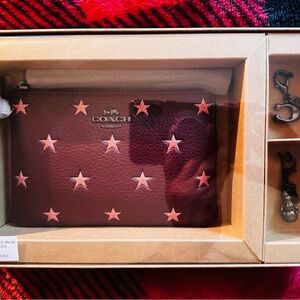 Coach wristlet NIB w/removable charms in Merlot w/glitter stars